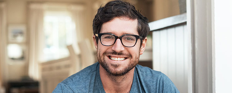 man with brown rimmed glasses and beard, smiling