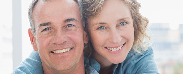 middle-aged husband and wife, smiling