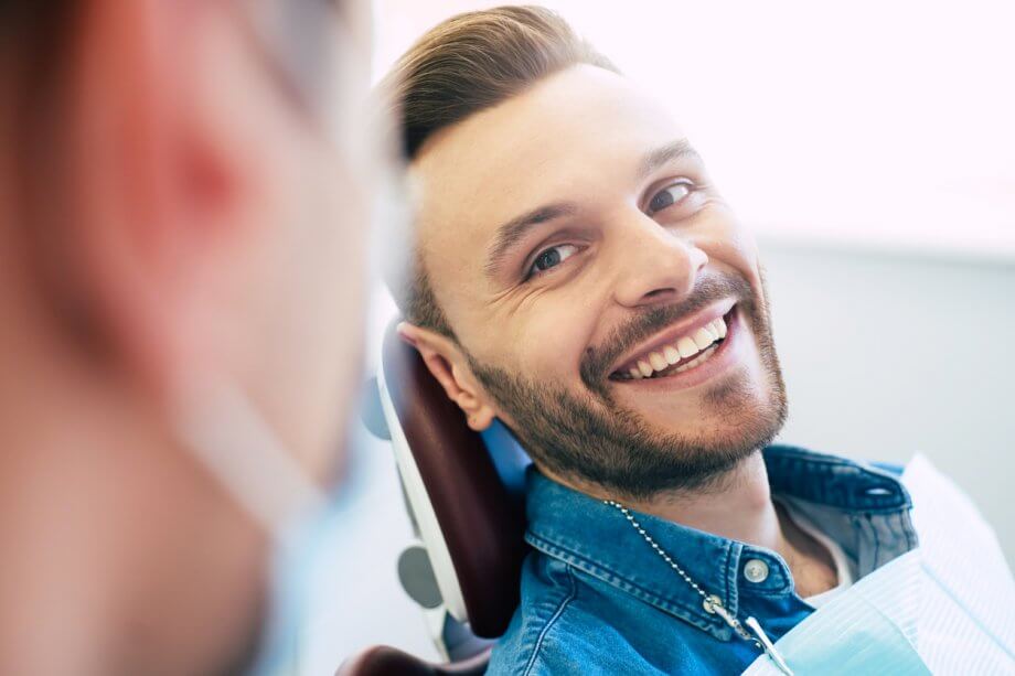 man smiling at the dentist