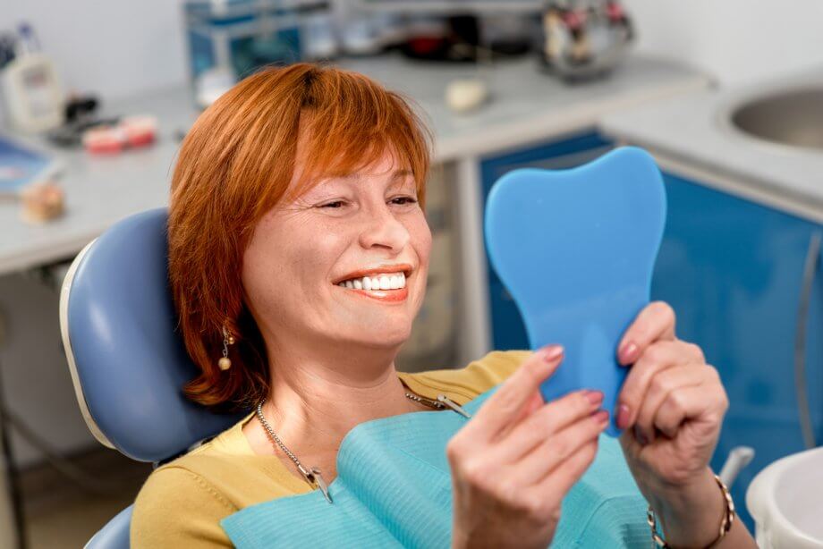 senior woman smiling at dentist