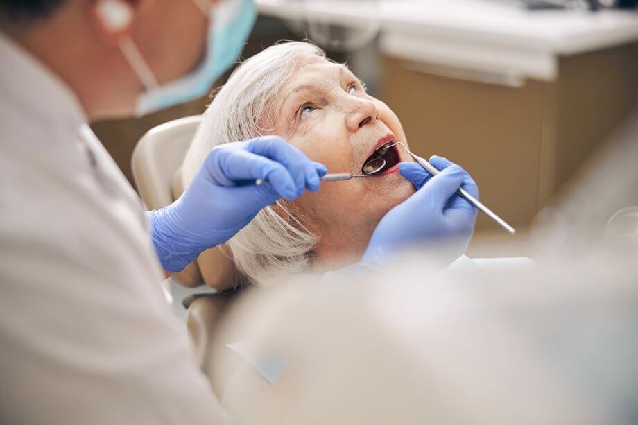 older woman receiving a dental exam