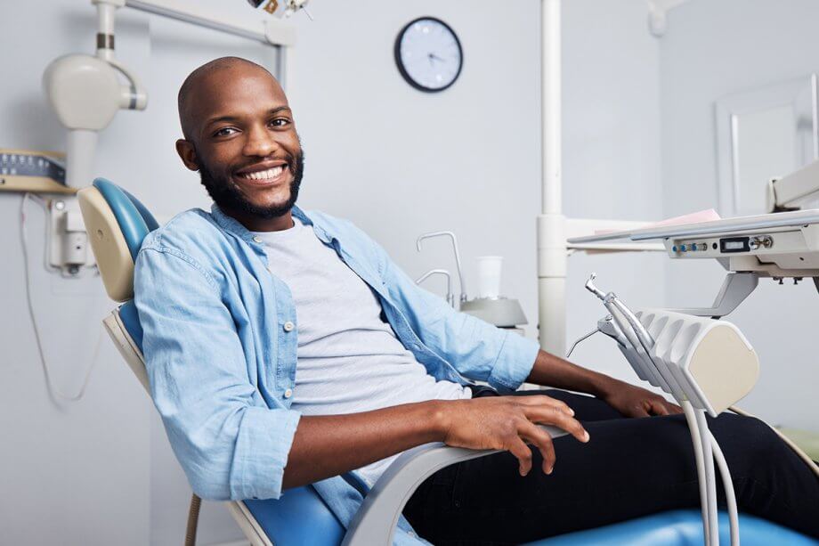 smiling man in dental exam chair